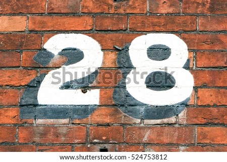 Number 28 painted on brick wall