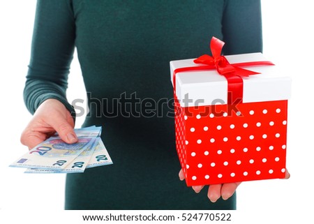 Close up picture of a woman holding a Christmas gift and money