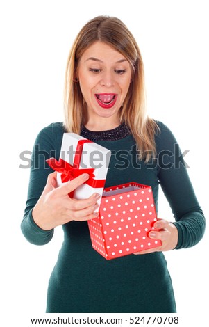 Picture of a surpised young woman holding her Christmas gift