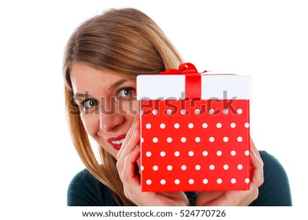 Picture of a happy woman holding a Christmas gift