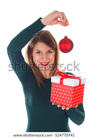 Picture of a beautiful smiling woman holding Christmas decoration