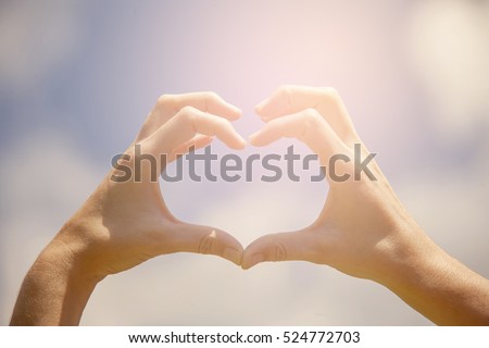 Heart shape hands on the blue sky Royalty-Free Stock Photo #524772703