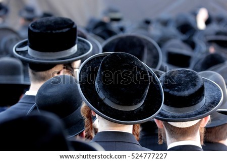 Crowd of anonymous hasidim  men walking on a Jerusalem street Royalty-Free Stock Photo #524777227