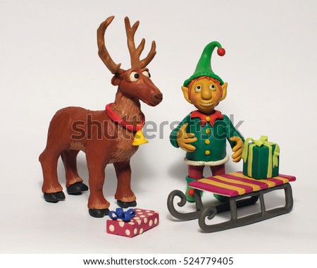 
Plasticine illustration Christmas elf and reindeer with gifts. Characters on a white background Royalty-Free Stock Photo #524779405