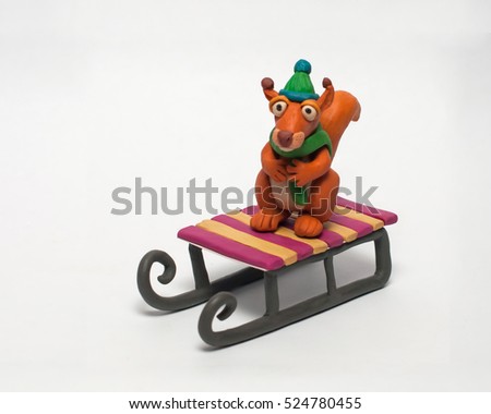
Funny plasticine squirrel in a green hat and scarf. Isolated character on white background Royalty-Free Stock Photo #524780455