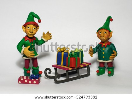 Two Christmas elf with gifts Royalty-Free Stock Photo #524793382