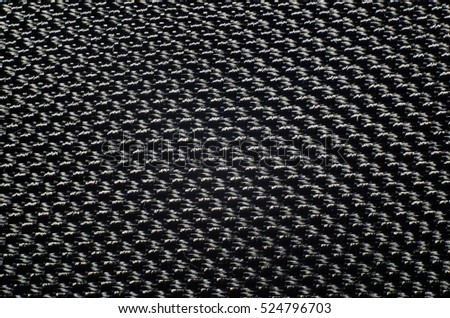 Perforated black textile pattern. Background or backdrop texture.