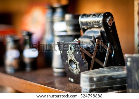 Old camera. vintage photography equipment on a shelf. very shallow depth of field.