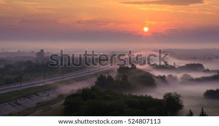 sunrise over misty river