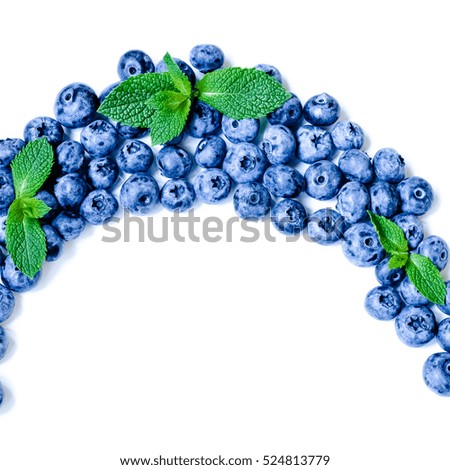 Fresh sweet blueberry fruit and leaf of mint.. Dessert healthy food. Group of ripe blue juicy organic berries. Raw summer diet. Delicious nature vegetarian ingredient. Wooden background.