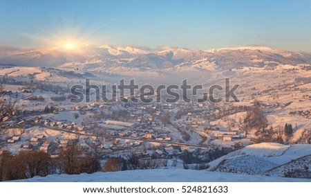 Winter fairytale, heavy snowfall covered the trees and houses in the mountain village.