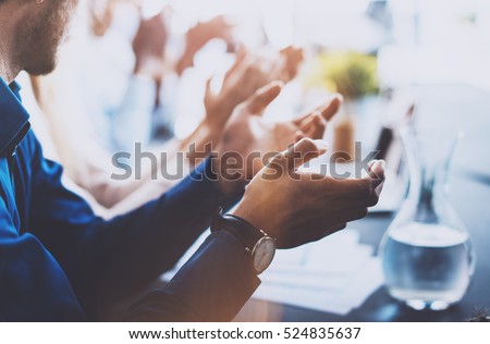 Close up view of young business partners applauding to reporter after listening report at seminar. Professional education, work meeting, presentation or coaching concept.Horizontal,blurred background Royalty-Free Stock Photo #524835637