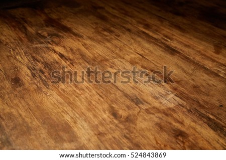 Aged wood desk in dim light Royalty-Free Stock Photo #524843869
