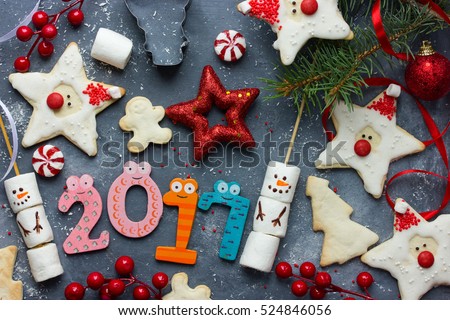 Happy New Year 2017 composition - holiday concept with gingerbread cookies, Christmas decoration and sweets, Christmas and New year food background