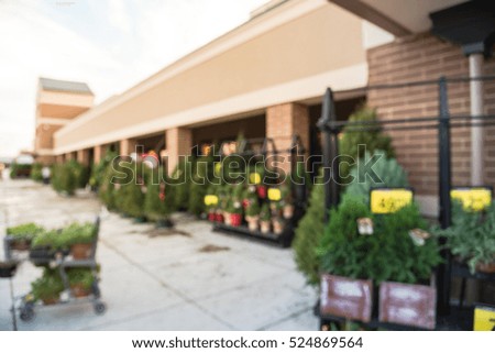 Blurred row of artificial Christmas trees for sale at storefront in Houston, Texas, US . Christmas with price tags displayed for sell at supermarket in America. Holiday and seasonal concept background