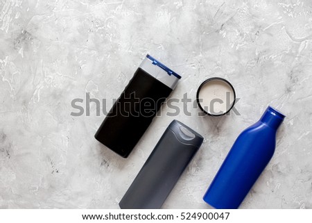 cosmetic for men in bottle on gray background top view