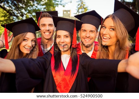 excited five successful happy five graduates in robes and hats with tassel together making selfie photo.