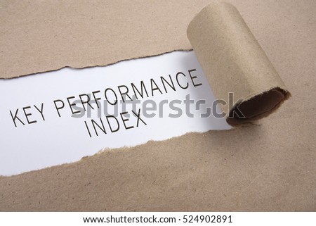 Torn brown paper on white surface with "key performance index" word.