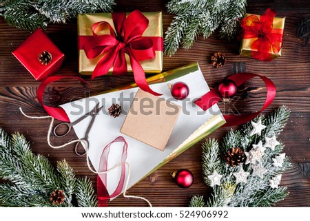 gifts boxes with fir branches on wooden background top view