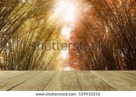 Empty top wooden table colorful background with bamboo forest