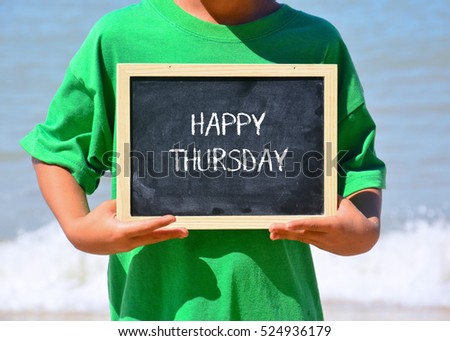 Kid holding a chalkboard written with HAPPY THURSDAY text. Wave and blue ocean background.