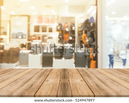 Wooden board empty table blurred background. Perspective brown wood over blur in department store - can be used for display or montage your products.Mock up for display of product.