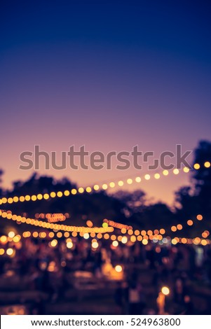 vintage tone blur image of night festival in garden with bokeh for background usage . Royalty-Free Stock Photo #524963800