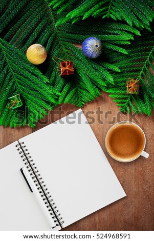Cup of coffee and christmas background on wooden table.