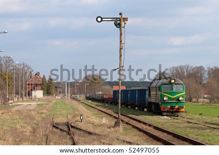 Freight train hauled by the diesel locomotive waiting at the station