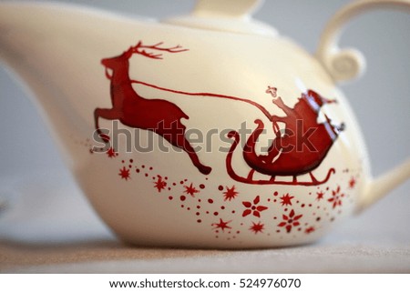 White Ceramic TeaPot with red deer and sled closeup