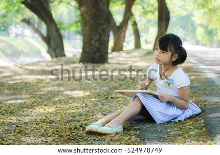 Asian Child Play Black Board In The Park
