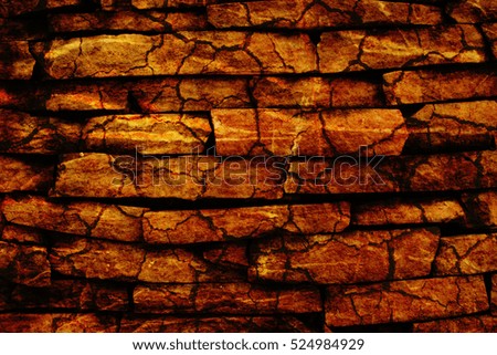 stone wall or crack stone wall with hard brown tone for background.