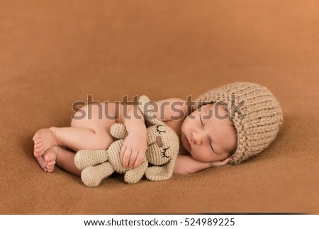 a small child sleeps with a favorite toy Royalty-Free Stock Photo #524989225