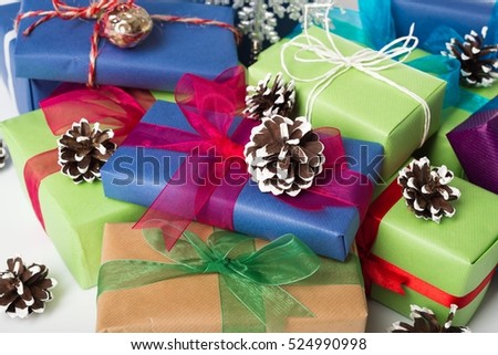 Closeup of wrapped Christmas presents with decorated pine cones