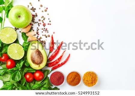 Detox food & drink lifestyle. Healthy food. Fresh vegetables fruit herbs & spices. Apple avocado lime tomatoes peppers herb & spices White background Free space. text layout Top view Royalty-Free Stock Photo #524993152