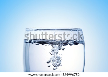 pouring water into a glass closeup with copy space Royalty-Free Stock Photo #524996752