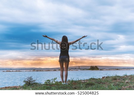 Yoga woman relaxing in summer sunset near sea
