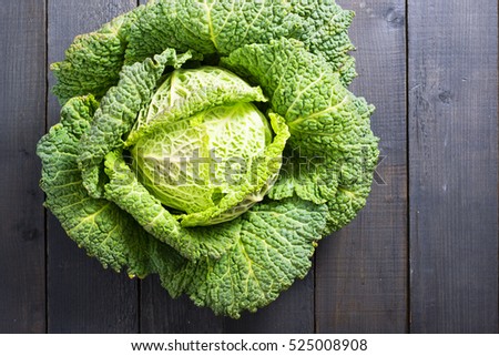 savoy cabbage from organic grower farm, on black wooden table Royalty-Free Stock Photo #525008908