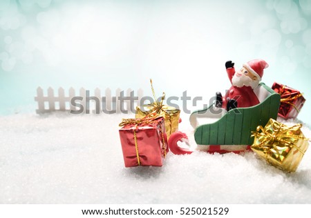 Christmas and winter concept, toy santa sleigh, gift boxes on snow background. Copy space for text in picture.