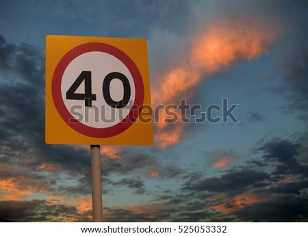 FORTY MILE AN HOUR ROAD SPEED LIMIT SIGN WITH TWILIGHT SKY BACKGROUND
