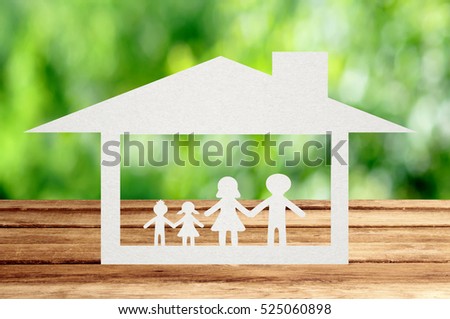 Paper family on wooden table with garden bokeh outdoor theme background.