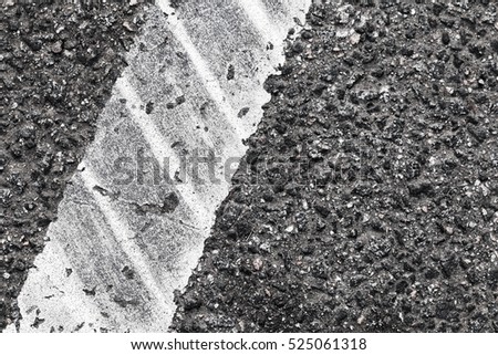 Rough dividing line fragment with tire tracks, highway road marking. Abstract transportation background