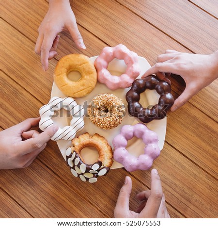 Friend Pick Donut from a Plate Top View Flat Lay