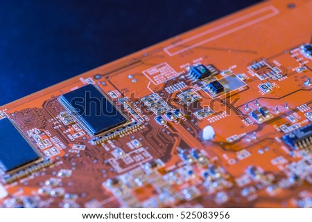 Macro shot of backside of orange computer circuit board