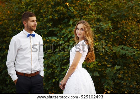 Bearded High fiance stylish with his beloved beautiful wife, short wedding dress, the bride a bit like a princess, romantic and funny couple