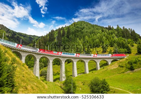 Train on famous landwasser Viaduct bridge.The Rhaetian Railway section from the Albula/Bernina area (the part from Thusis to Tirano, including St Moritz), Switzerland, Europe. Royalty-Free Stock Photo #525106633