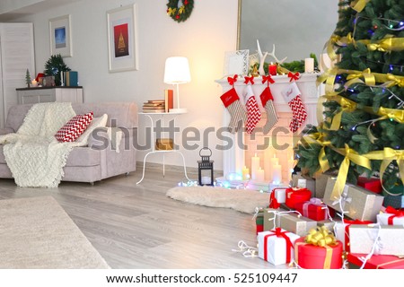 Interior of beautiful living room with fireplace decorated for Christmas