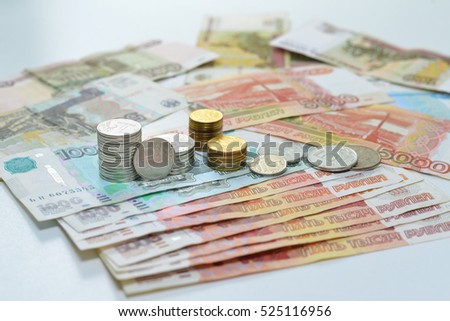 Russian roubles, coin stacks are on the bills
