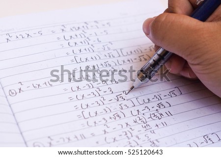 Doing difficult math homework / Solving Exponential Equations Royalty-Free Stock Photo #525120643