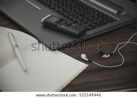 journalist's work at a computer with a voice recorder Royalty-Free Stock Photo #525149446